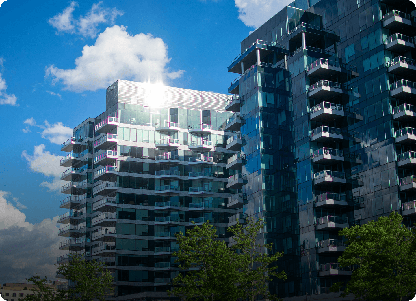 Modern glass apartment building on a sunny day